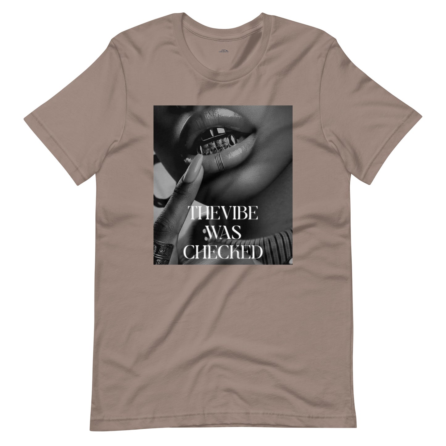 Beige graphic t-shirt featuring a bold black-and-white print of lips with a grill and the phrase "THE VIBE WAS CHECKED.