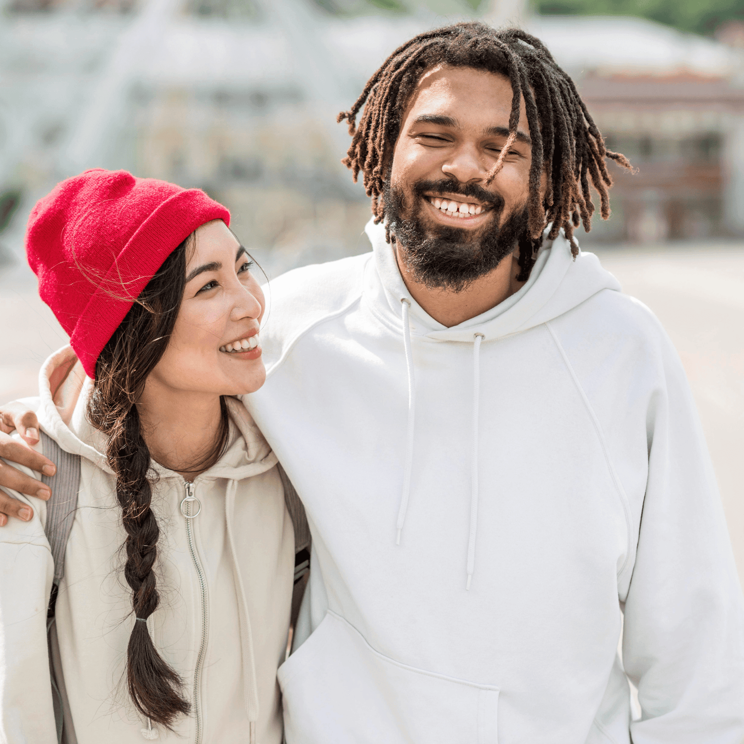 A man and woman wearing a black hoodie with Paper Coconuts embroidered logo design, adding a touch of uniqueness to his outfit.