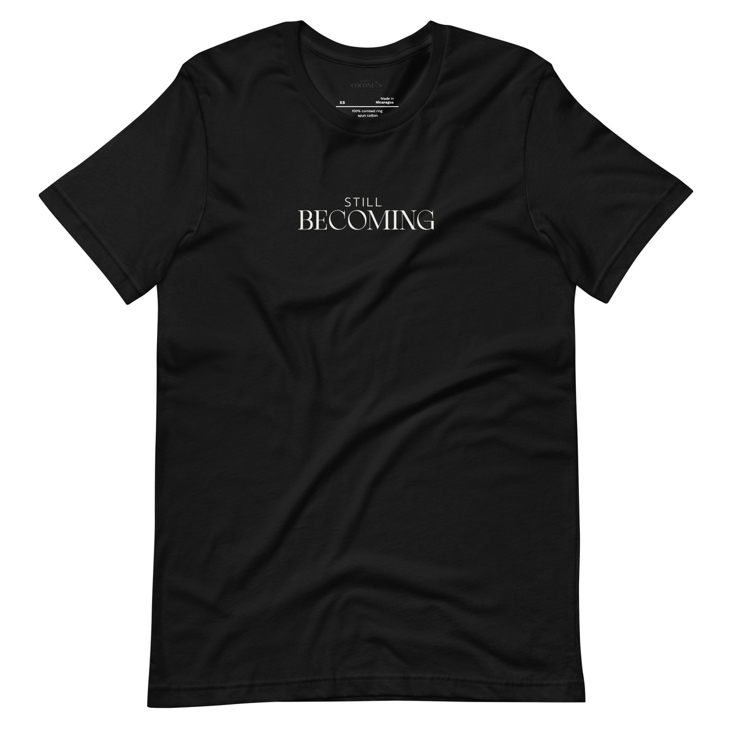 Black unisex graphic t-shirt with Still Becoming text design by Paper Coconuts, minimalist style for everyday comfort